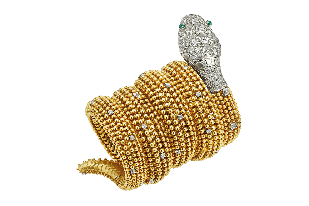Serpenti bracelet watch in gold with emeralds eyes and diamonds, ca 1955