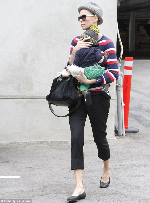 And off she goes: Charlize seemed to be enjoying the fresh air as she strolled around with her adopted son Jackson