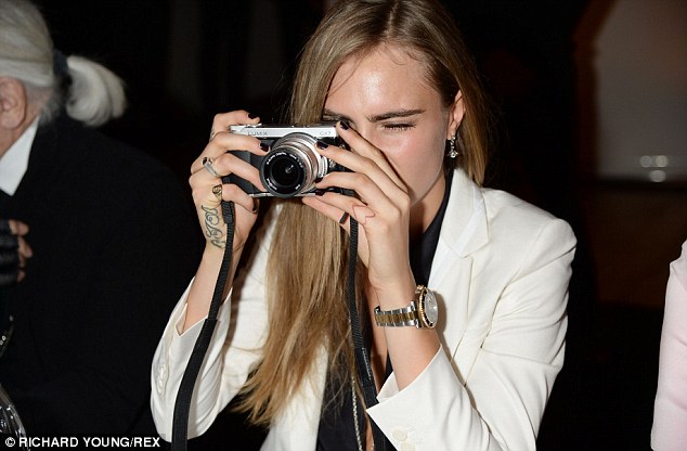 Say cheese! The supermodel was rather taken with a camera and snapped away - the event was in aid of Karl Lagerfeld
