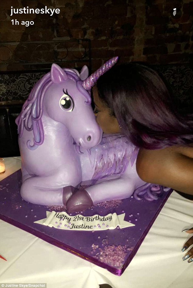 Too sweet to eat: Inside the venue, Justine was presented with a giant purple unicorn cake, as the star - who has purple hair - is also known by her nickname Purple Unicorn