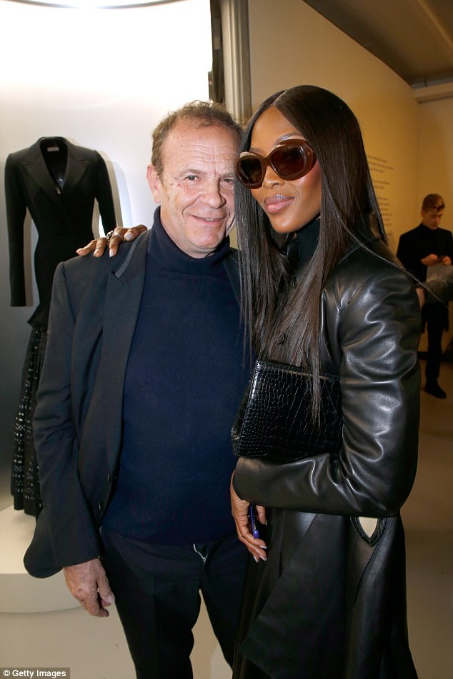 Rubbing shoulders: Naomi, who stopped to take a quick photo with French novelist Francois-Marie Banier, caught all the attention in a mid-length black leather jacket, with numerous buttons down the edgy outerwear