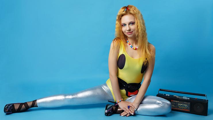 Woman in Spandex leggings sits in blue room with radio